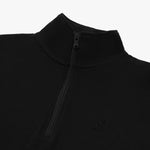 Close-up of a black quarter-zip pullover featuring a high collar and a black zipper. The pullover has a subtle embroidered dog logo on the chest, blending seamlessly with the monochromatic design