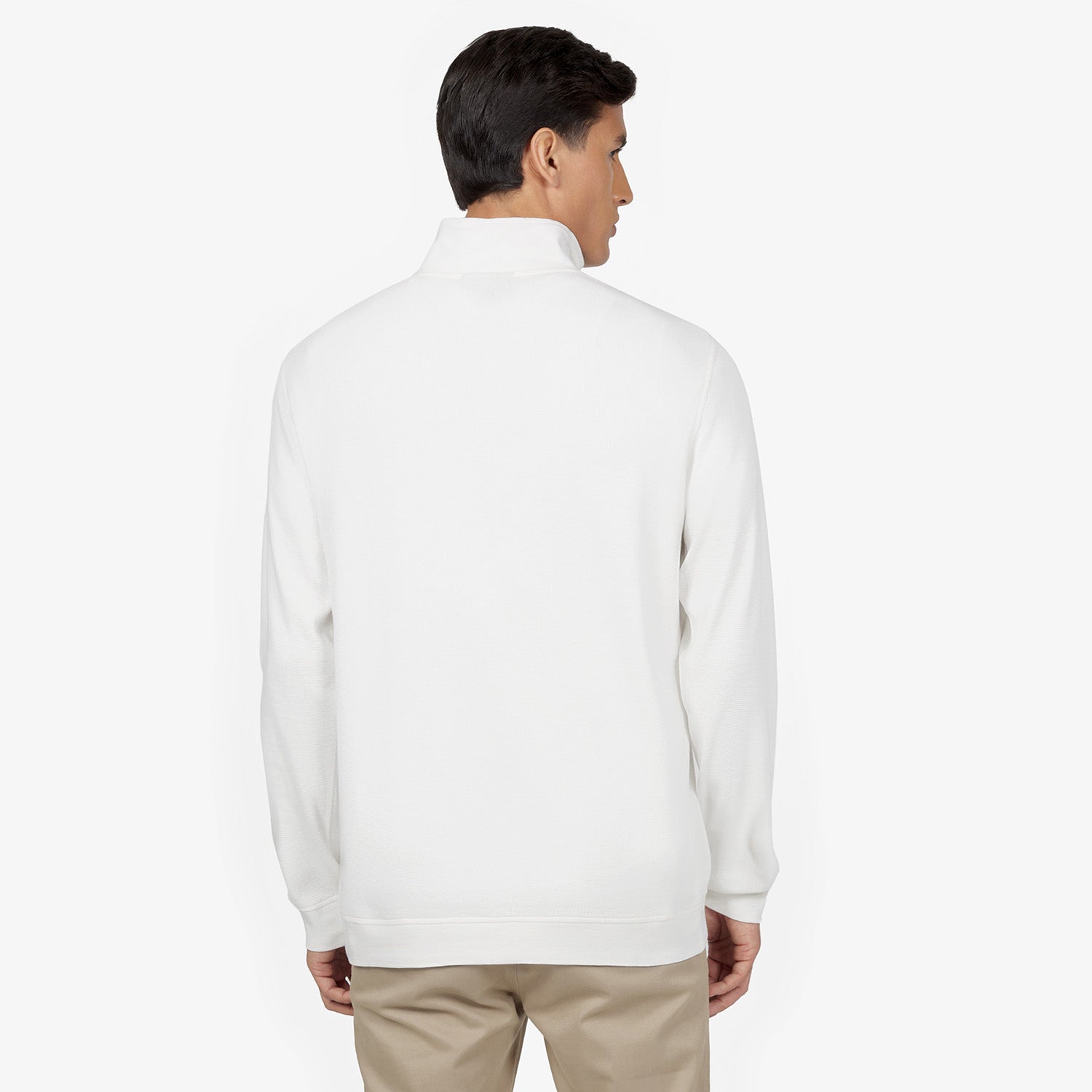 Man wearing a white half-zip sweatshirt viewed from the back. The sweatshirt has a clean, minim