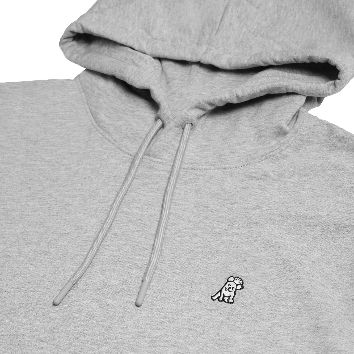 Close-up of the chest area of the gray hoodie, highlighting the embroidered dog logo and textured fabric