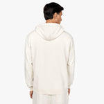 Back view of a man wearing an off-white hoodie with a plain design and a hood, paired with matching off-white sweatpants. The outfit is displayed against a plain white background." Let me know if you'd like any adjustments