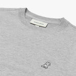 Close-up of the embroidered dog logo on the light gray crewneck sweatshirt.