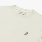 Close-up of the embroidered dog logo on the ivory crewneck sweatshirt