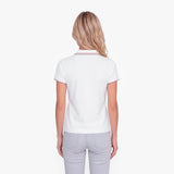 Back view of a woman wearing a white polo with an embroidered dog logo on a white background
