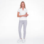 Women wearing a white polo with an embroidered dog logo on a white background