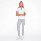 Women wearing a white polo with an embroidered dog logo on a white background
