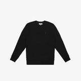 A black crewneck sweatshirt laid flat on a white background. It features long sleeves, ribbed cuffs, and a ribbed hem. A subtle embroidered logo, matching the black fabric, is positioned on the left chest area. The neckline includes a white label with black text displaying the brand "JAMES BARK." The fabric appears soft and comfortable.