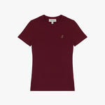 A burgundy short-sleeve T-shirt laid flat on a white background. It features a ribbed crewneck collar and a fitted silhouette. A small embroidered logo of a dog in a slightly darker shade is positioned on the left chest area. The neckline includes a white label with black text displaying the brand "JAMES BARK" and the size "S." The fabric appears soft and high-quality.