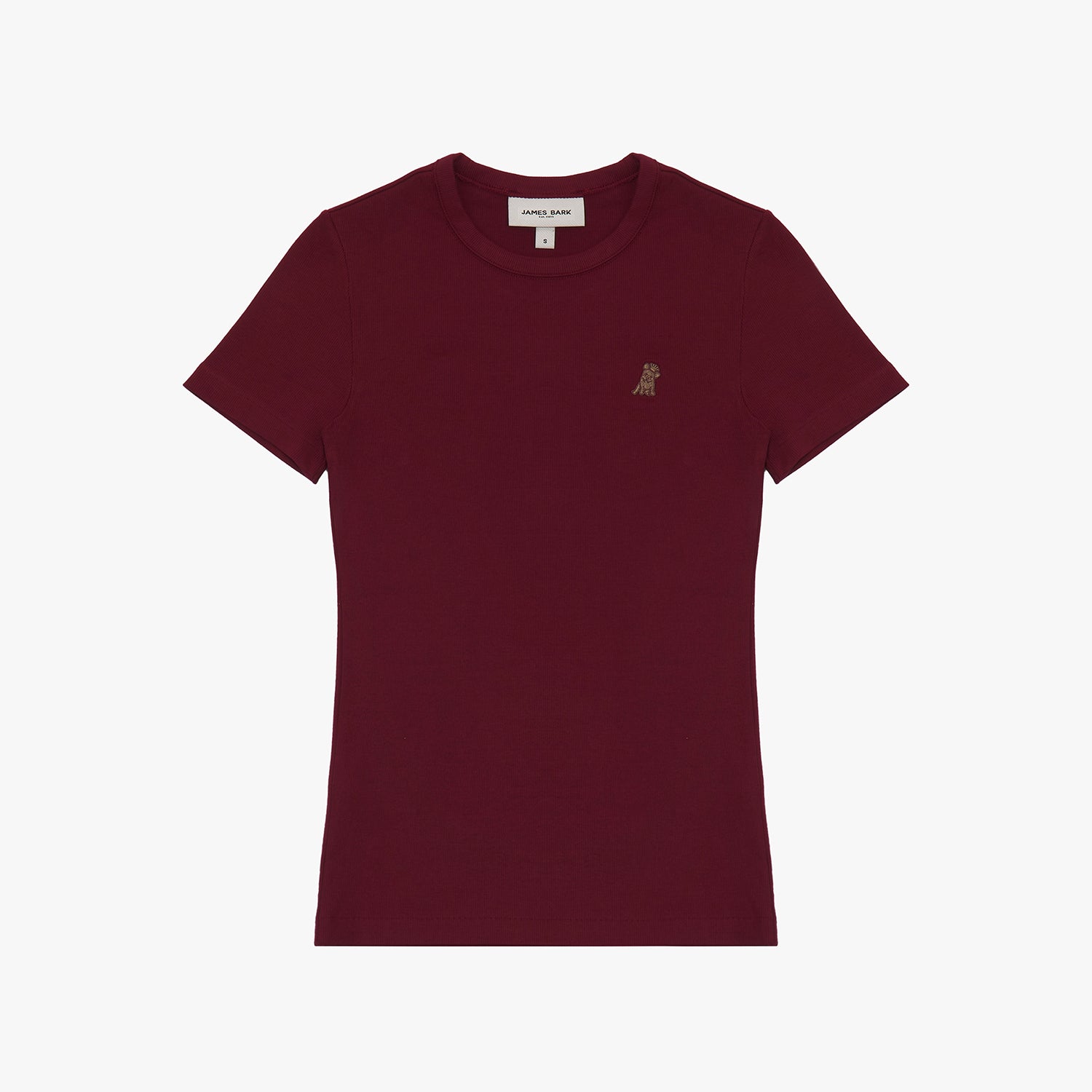 A burgundy short-sleeve T-shirt laid flat on a white background. It features a ribbed crewneck collar and a fitted silhouette. A small embroidered logo of a dog in a slightly darker shade is positioned on the left chest area. The neckline includes a white label with black text displaying the brand "JAMES BARK" and the size "S." The fabric appears soft and high-quality.