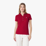 Woman wearing a red polo shirt with a logo on a white background