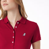 Close-up of a red polo shirt with a small logo on a white background