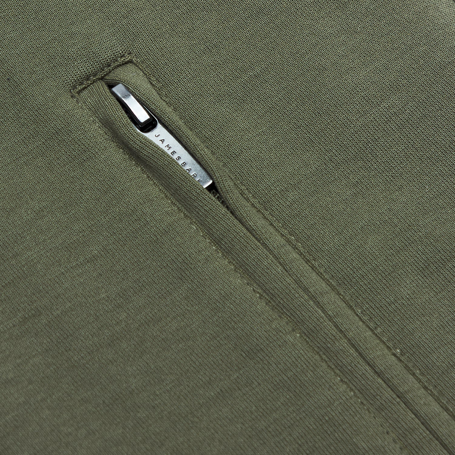  A detailed close-up of a zippered pocket on the vest.