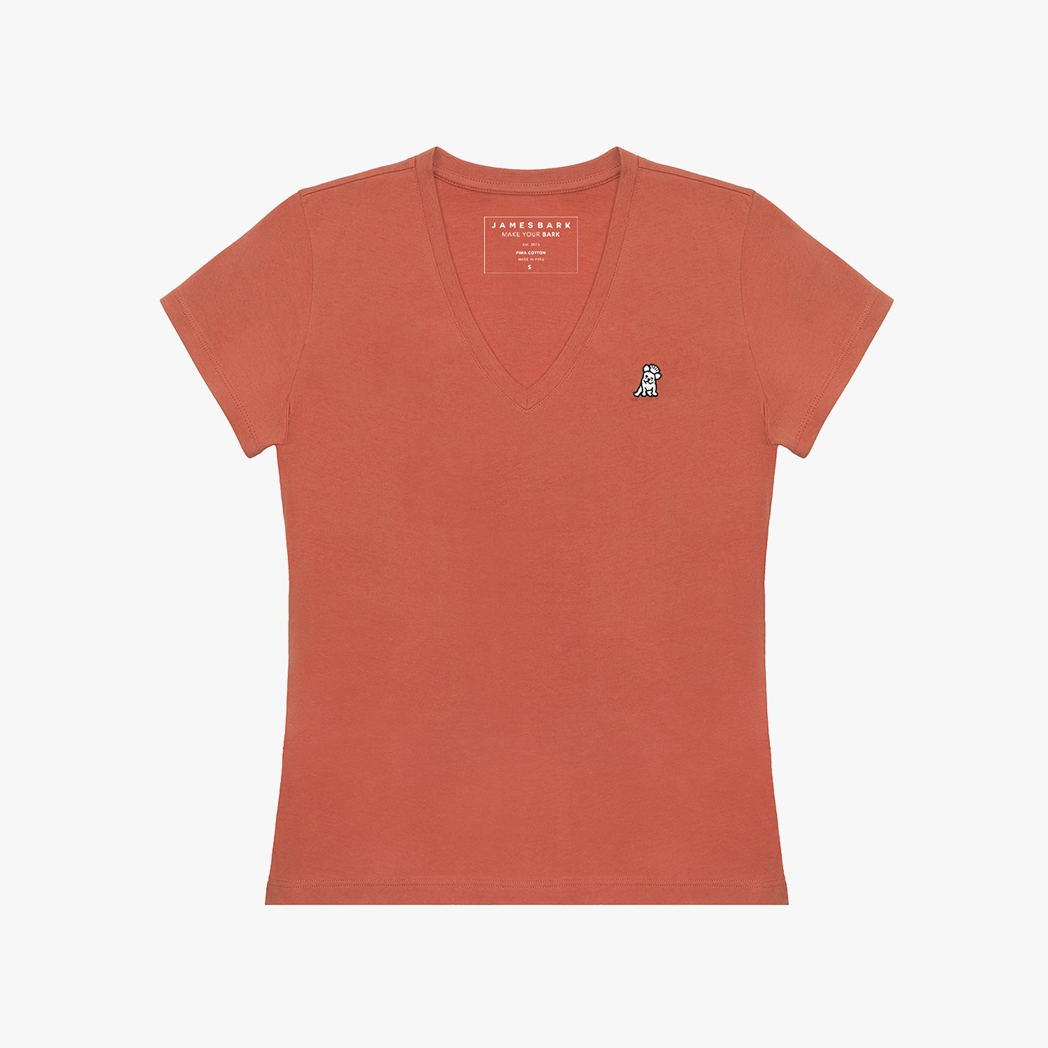 Detailed close-up view of a terracotta-colored women's t-shirt's V-neck, showing the printed internal brand tag "JAMES BARK" and the black and white embroidered dog logo just below it on the left chest