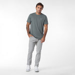 Man wearing a gray t-shirt and pants on a white background