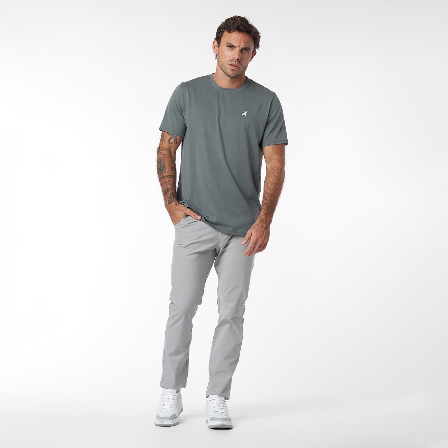 Man wearing a gray t-shirt and pants on a white background
