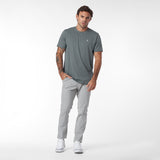 Man wearing a gray t-shirt and pants on a white background