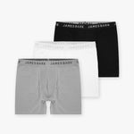 A set of three men's boxer briefs in different colors, arranged in a staggered stack. The boxer briefs are in black, white, and gray, each with a waistband featuring the 'JAMES BARK' brand name printed repeatedly around it.