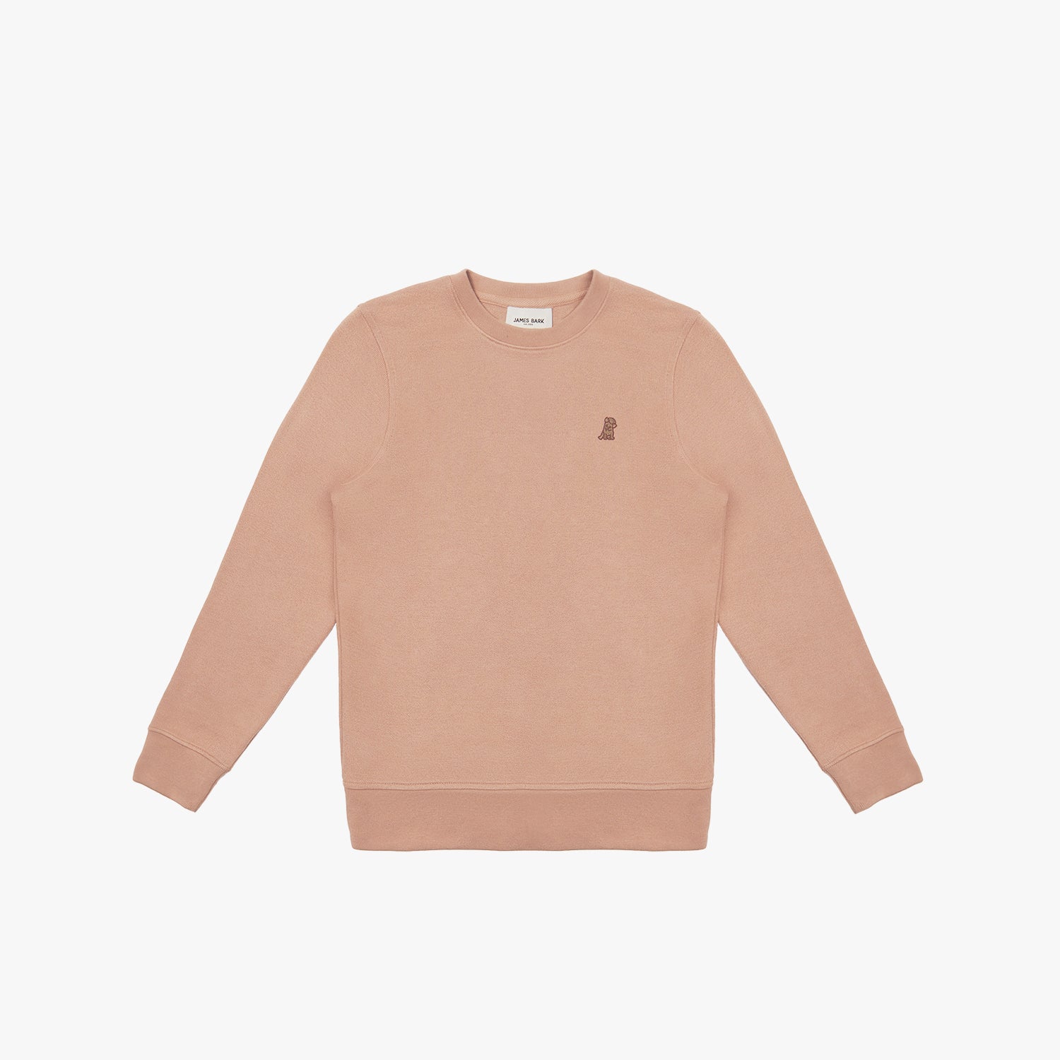 A dusty rose-colored crewneck sweatshirt laid flat on a white background. It features long sleeves, ribbed cuffs, and a ribbed hem. A small embroidered logo of a dog in a slightly darker shade is positioned on the left chest area. The neckline includes a white label with black text displaying the brand "JAMES BARK." The fabric appears soft and comfortable.