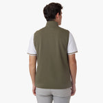 A back view of the model wearing the olive-green vest, highlighting its fit and structure.