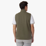 A back view of the model wearing the olive-green vest, highlighting its fit and structure.